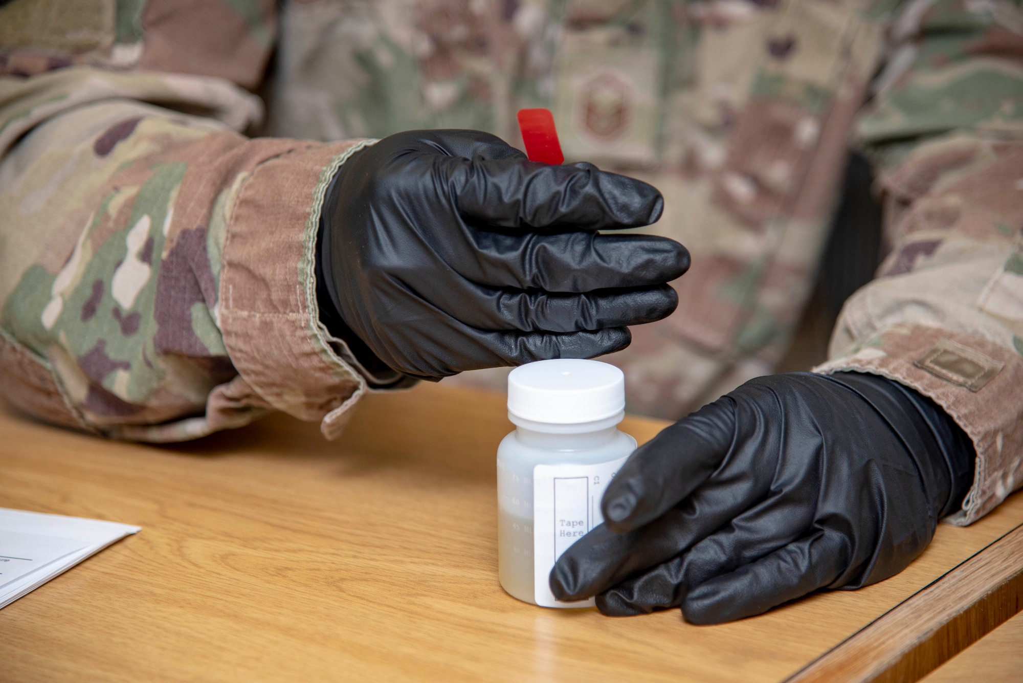 Master Sgt. Jason Maldonado, 436th Air Wing Drug Demand Reduction Program collector, seals a urine sample in the bottle November 8, 2019.  The samples are then inspected and packed before being shipped out to be tested at the Forensic Toxicology Drug Testing Laboratory at Lackland AFB, Texas, for any potential drugs. (U.S. Air Force photo by Staff Sgt. Nicole Leidholm)