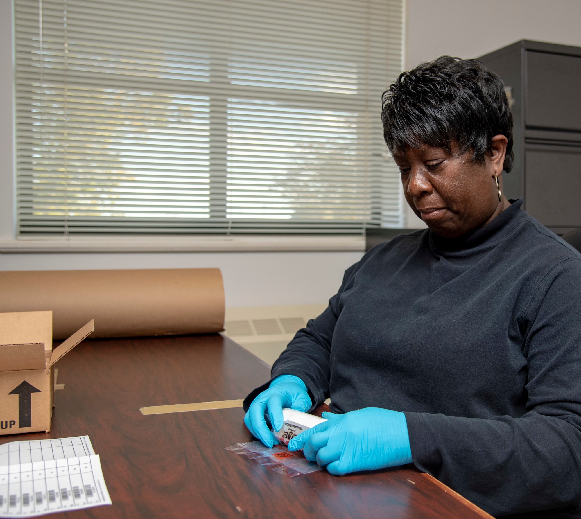 Avonda Johnson, 436th Air Wing Drug Testing Program Administrative manager, preps a urine sample for be shipped for testing November 8, 2019. The samples are shipped to the Forensic Toxicology Drug Testing Laboratory. (U.S. Air Force photo by Staff Sgt. Nicole Leidholm)