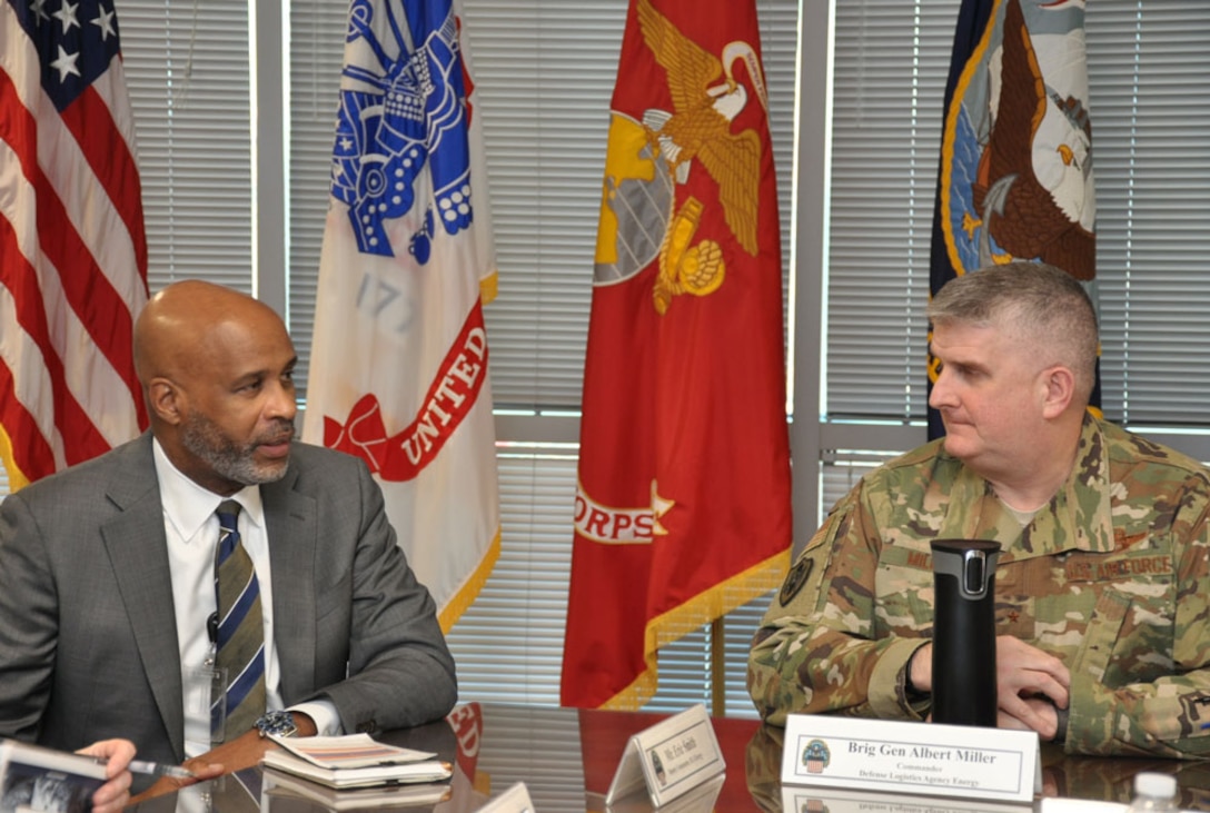 Air Force Brig. Gen. Albert G. Miller confers with Eric Smith