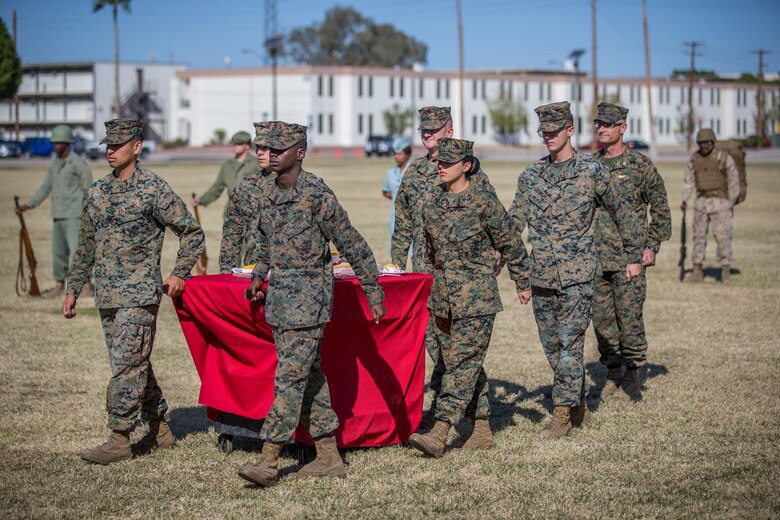 U.S. Marines with Headquarters and Headquarters Squadron, Marine Corps Air Station (MCAS)Yuma, participate in the 244th Marine Corps birthday uniform pageant at the Parade Deck on MCAS Yuma, Ariz., Nov. 7, 2019. The annual ceremony was held in honor of the 244th Marine Corps birthday, showcasing historical uniforms to honor Marines of the past, present and future while signifying the passing of traditions from one generation to the next. (U.S. Marine Corps photo Lance Cpl. John Hall)