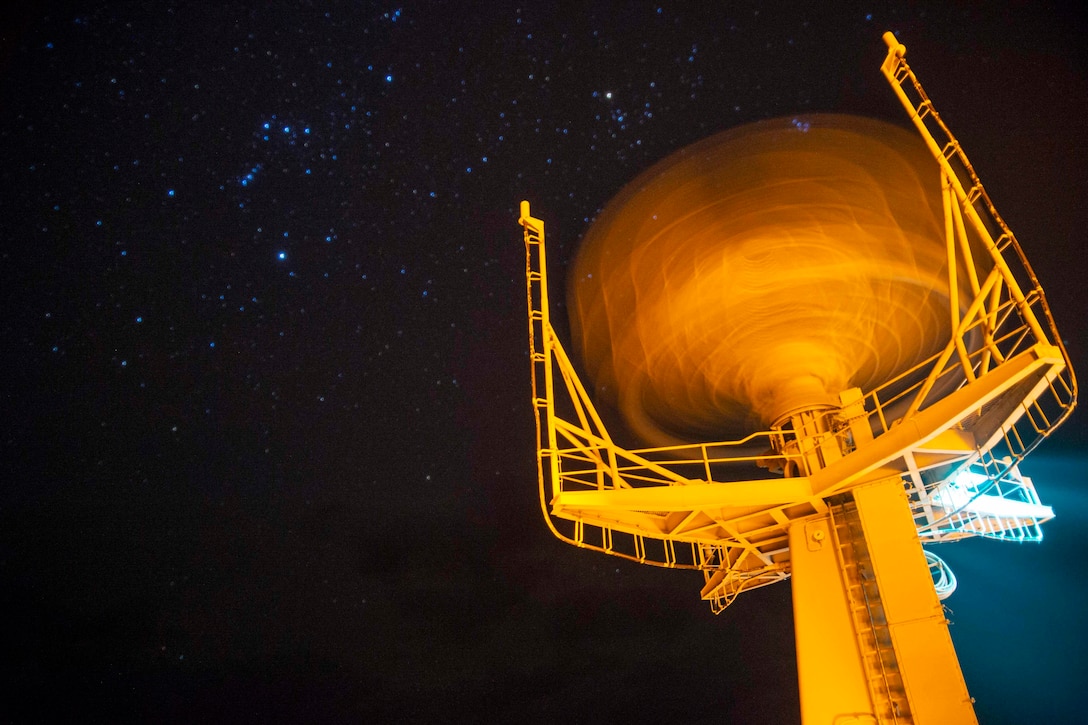 A radar with the night sky in the background.