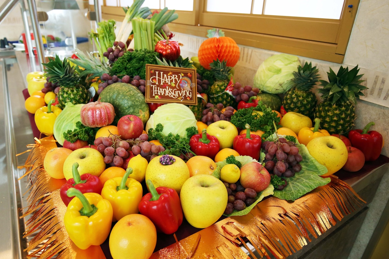 A large group of fruit and vegetables displayed on a table.