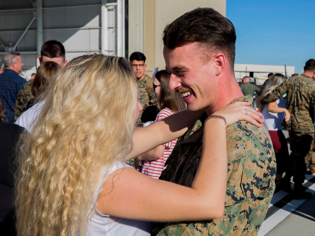 A Marine with Marine Medium Tiltrotor Squadron (VMM) 163, Marine Aircraft Group (MAG) 16, 3rd Marine Aircraft Wing (MAW), is welcomed home by a loved one on Marine Corps Air Station Miramar, Calif., Nov. 25, 2019. VMM-163 supported the 11th Marine Expeditionary Unit during routine operations as part of the Boxer Amphibious Ready Group in the Eastern Pacific Ocean. (U.S. Marine Corps photo by Lance Cpl. Jaime Reyes)