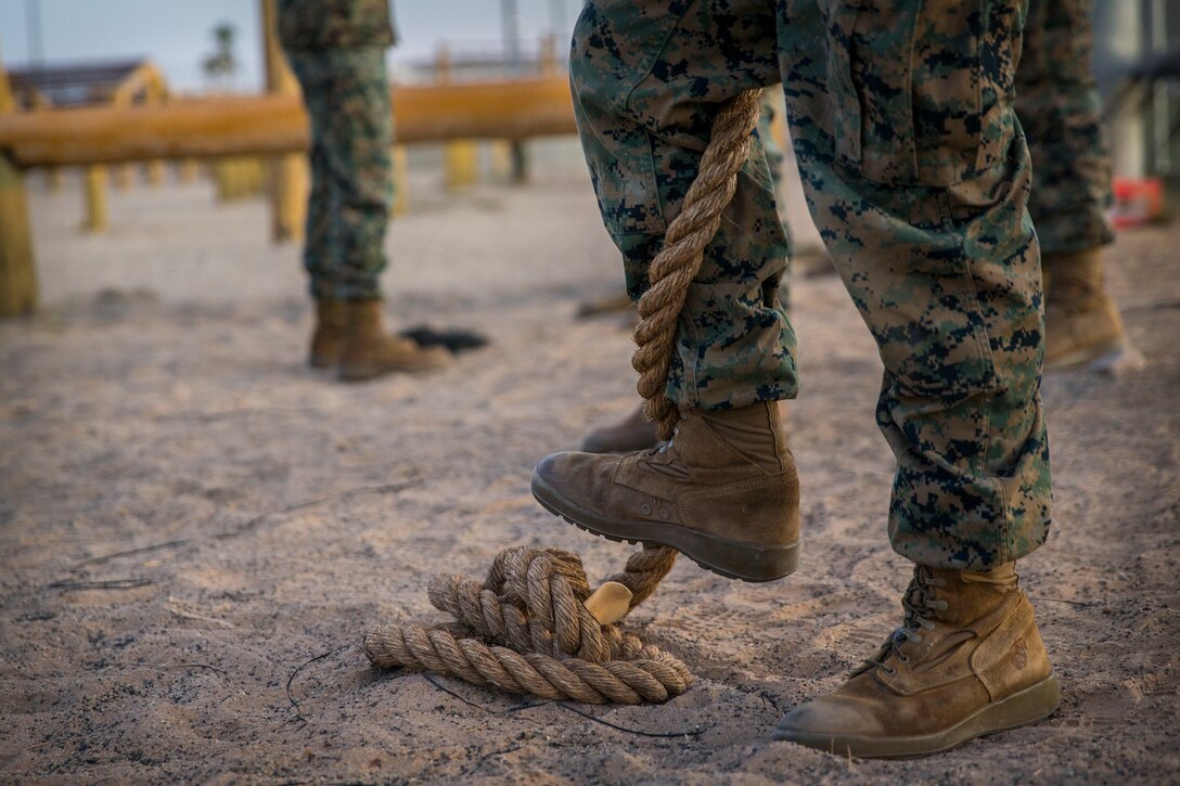 U.S. Marines and Sailors with Headuarters and Headquarters Squadron, Marine Corps Air Staion (MCAS) Yuma, participate in a squadron-wide obstacle course exercise on Nov. 8, 2019. The Marine Corps obstacle course is composed of various obstacles such as high and low logs, high bars, incline bars and traverse logs, and a rope climb. (Marine Corps photo by Lance Cpl. John Hall)