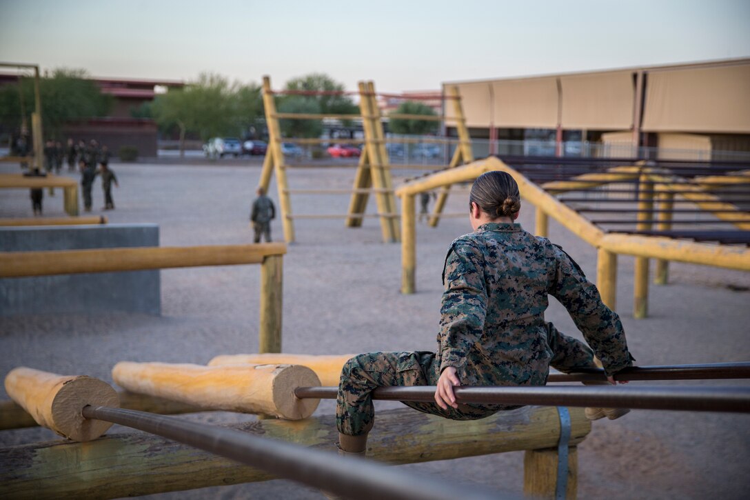 U.S. Marines and Sailors with Headuarters and Headquarters Squadron, Marine Corps Air Staion (MCAS) Yuma, participate in a squadron-wide obstacle course exercise on Nov. 8, 2019. The Marine Corps obstacle course is composed of various obstacles such as high and low logs, high bars, incline bars and traverse logs, and a rope climb. (Marine Corps photo by Lance Cpl. John Hall)