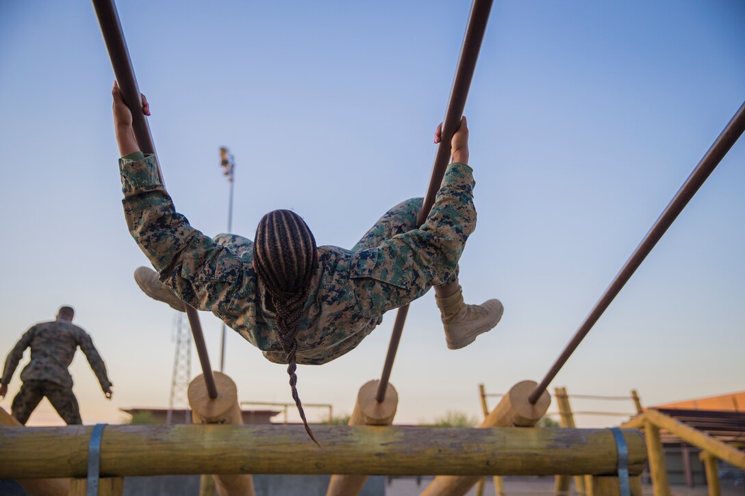 U.S. Marines and Sailors with Headuarters and Headquarters Squadron, Marine Corps Air Staion (MCAS) Yuma, participate in a squadron-wide obstacle course exercise on Nov. 8, 2019. The Marine Corps obstacle course is composed of various obstacles such as high and low logs, high bars, incline bars and traverse logs, and a rope climb. (Marine Corps photo by Lance Cpl. John Hall)