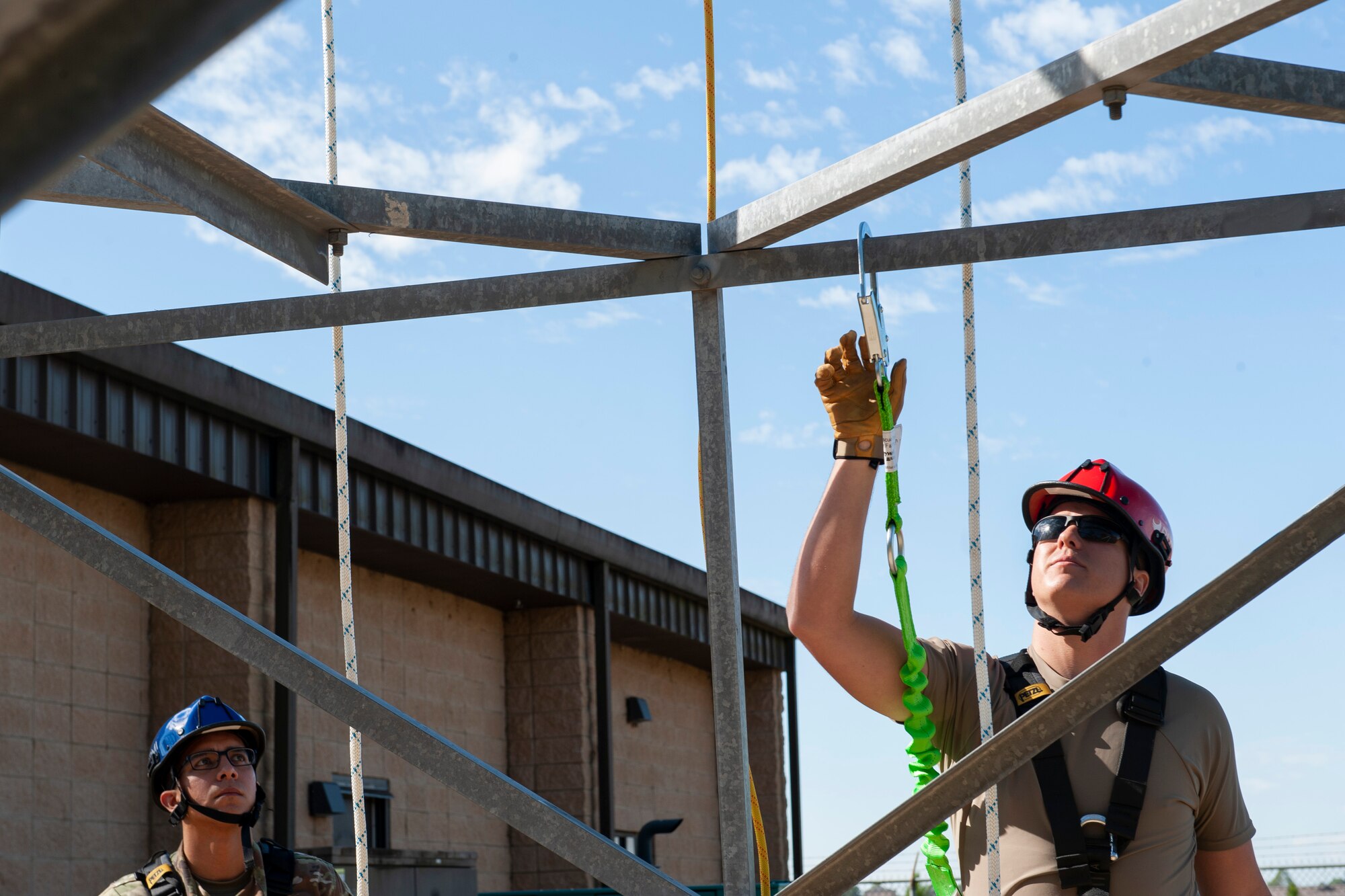 A photo of Airmen preparing to climb a radio tower