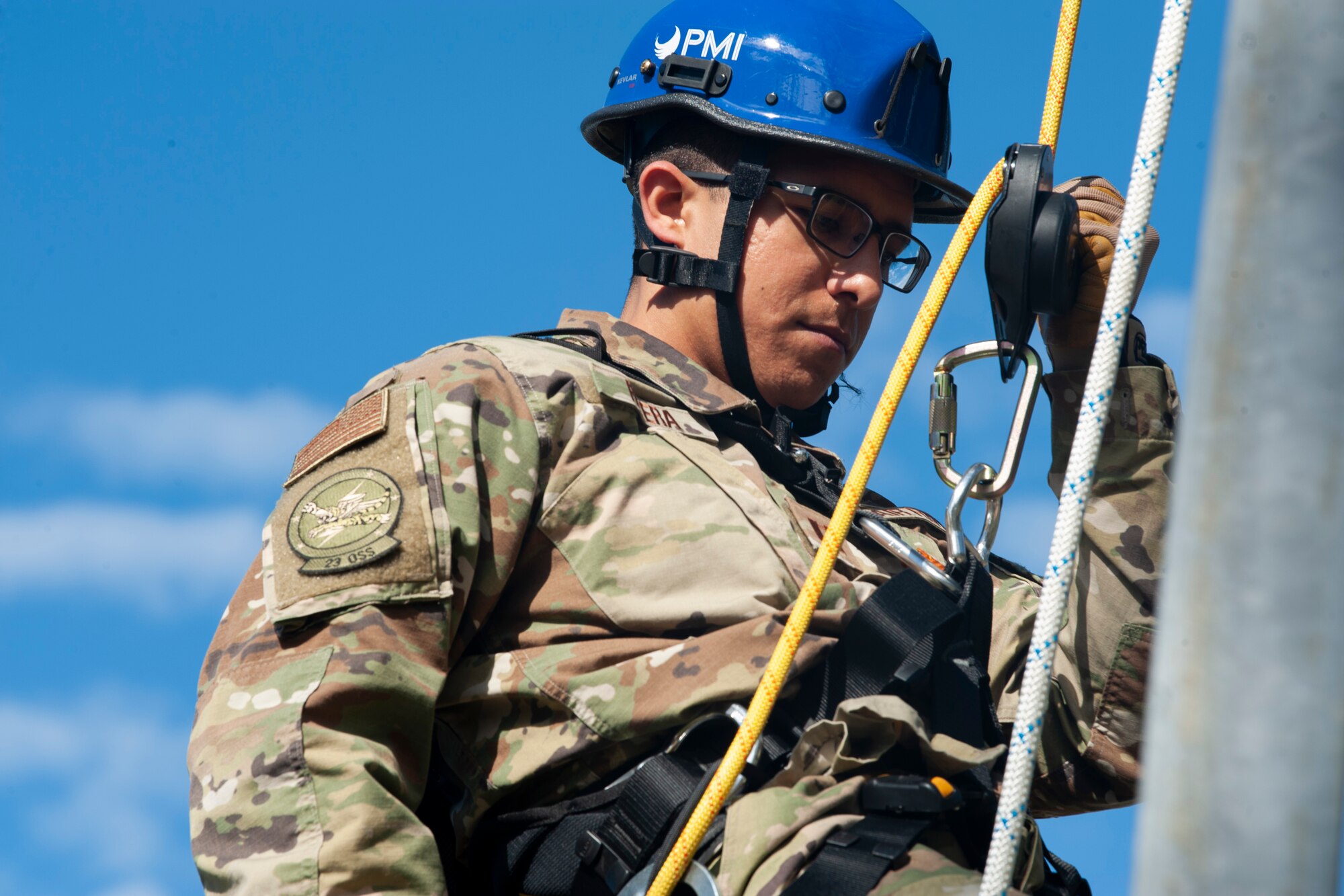 A photo of an Airman rappelling from a radio tower
