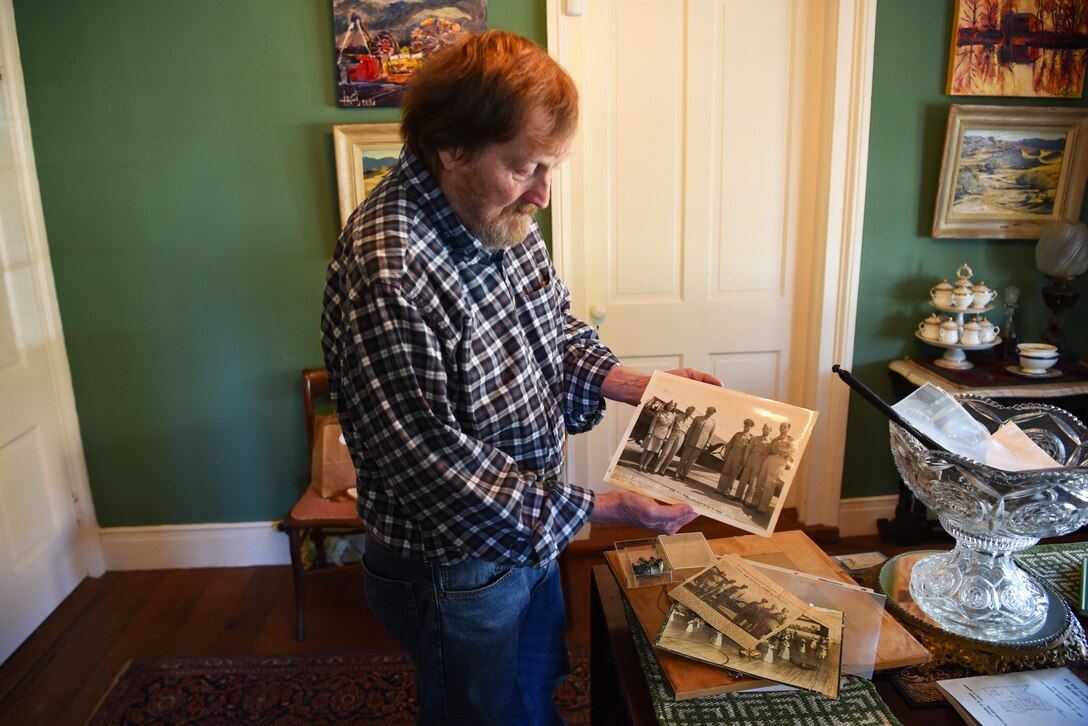 Rufus Ward, honorary commander of the 43rd Flying Training Squadron, holds up a picture of his mother with other CAP members and commanders, Nov. 20, 2019, in Columbus, Miss. Ida Ward had the distinction of being the first female to solo in the Columbus CAP unit. (U.S. Air Force photo by Airmen 1st Class Jake Jacobsen)