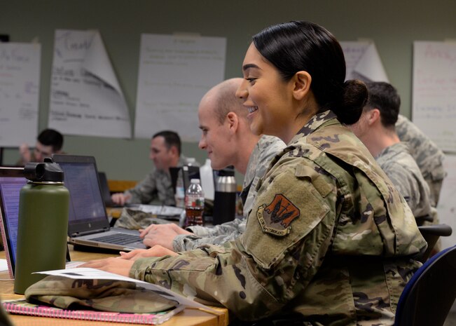 A photo of Airmen sitting in desks during a Airmen Leadership School class