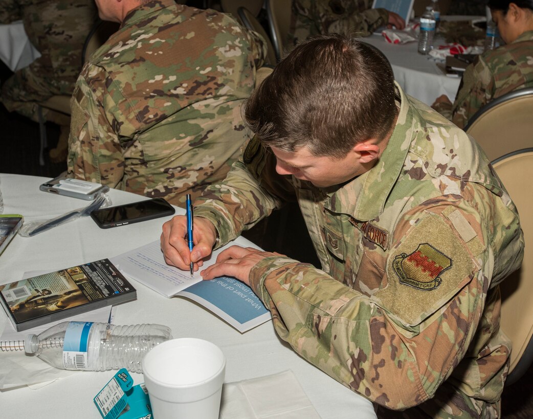 Tech. Sgt. Eric Childress, Airman and Family Readiness Center readiness noncommissioned officer, journals in his workbook at Shaw Air Force Base, South Carolina, Nov. 21, 2019.