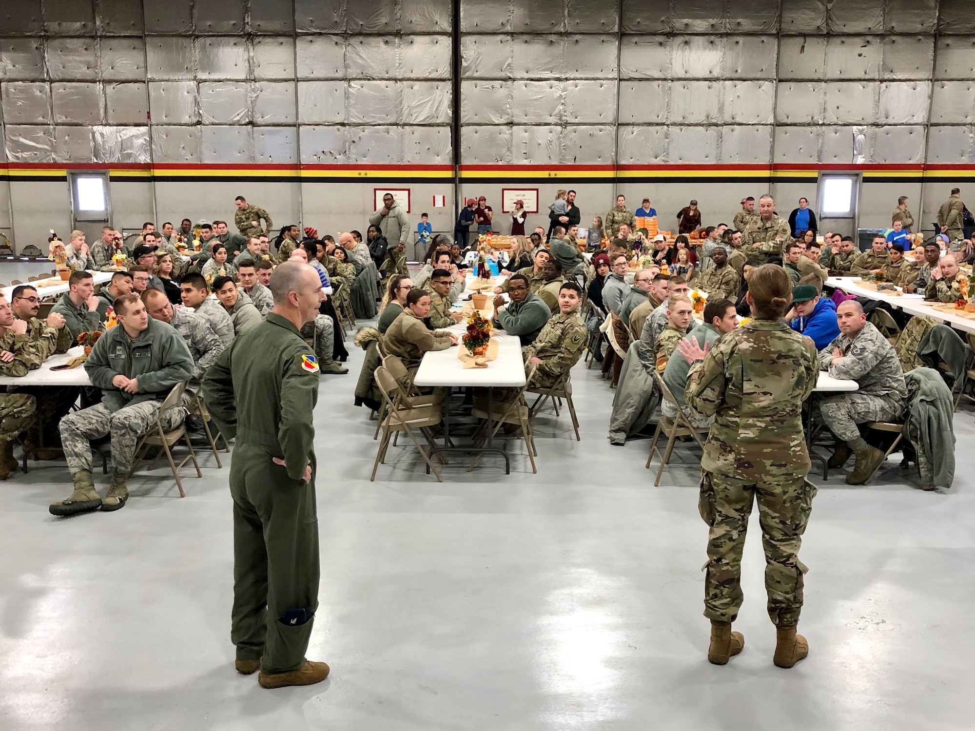 Col. Gina Sabric, 419th Fighter Wing commander, and Col. Steven Behmer, 388th FW commander, greet Airmen before a huge feast Nov. 27