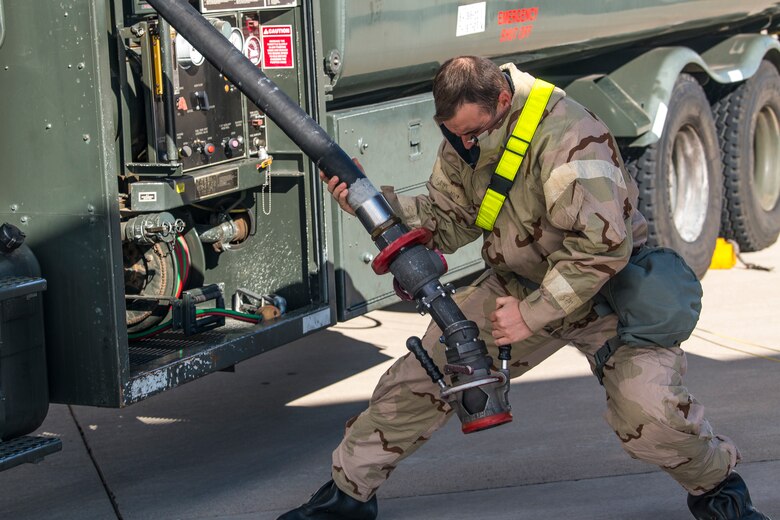 Senior Airman Mitchell Moore, 27th Special Operations Logistics Readiness Squadron fuels journeyman, pulls down a fuel hose to refuel an aircraft during an Operational Readiness Assessment at Cannon Air Force Base, N.M., Nov. 20, 2019. Participants of the ORA included members from across the base. (U.S. Air Force photo by Senior Airman Vernon R. Walter III)