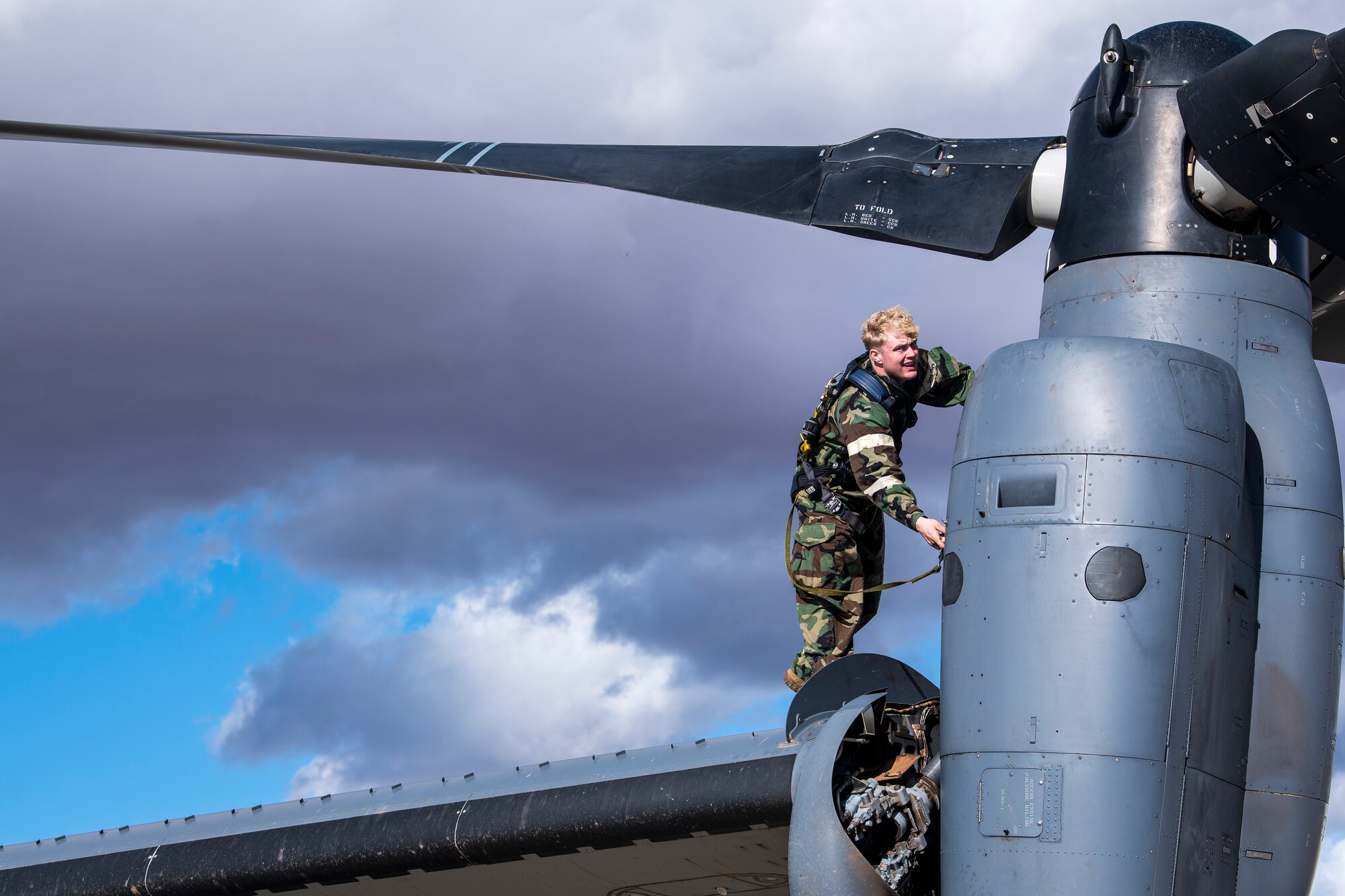 Staff Sgt. David Page, 727th Special Operations Aircraft Maintenance Squadron crew chief, checks his harness during maintenance on a CV-22 Osprey during an Operational Readiness Assessment at Cannon Air Force Base, N.M., Nov. 20, 2019. The ORA had Air Commandos wearing up to 40 pounds of equipment during high-tempo operations while quickly switching between levels of Mission Oriented Protective Posture gear. (U.S. Air Force photo by Senior Airman Vernon R. Walter III)