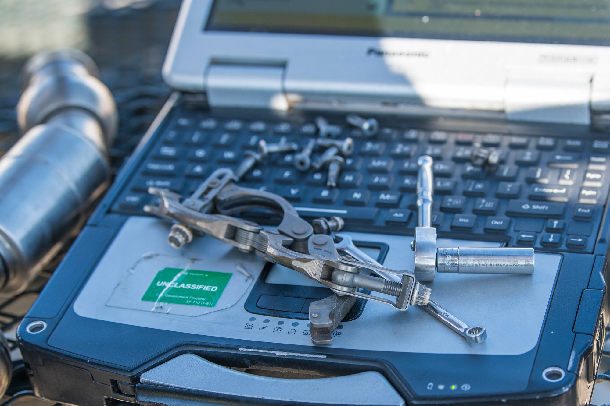 Tools are strewn on a laptop on the flightline during an Operational Readiness Assessment at Cannon Air Force Base, N.M., Nov. 20, 2019. Cannon has participated in three operational readiness exercises to prepare themselves for the assessment by Air Force Special Operations Command. (U.S. Air Force photo by Senior Airman Vernon R. Walter III)