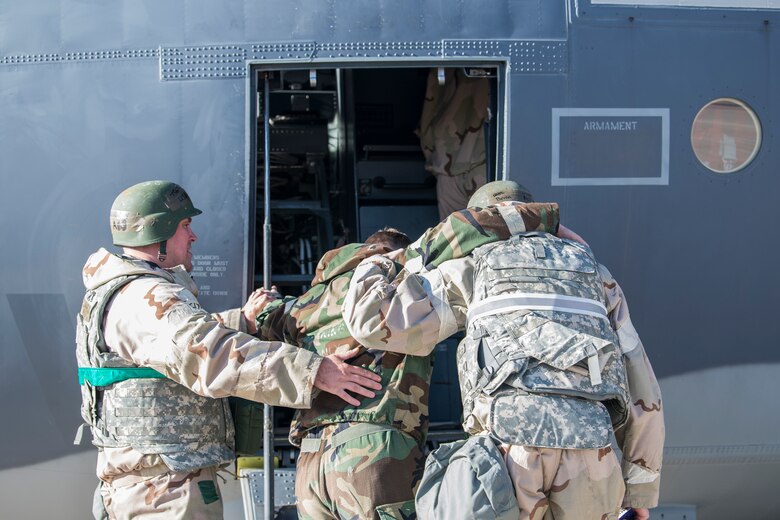 Cannon Airmen bring aboard a teammate who was hit by simulated sniper fire during an operational readiness assessment at Cannon Air Force Base, N.M., Nov. 20, 2019. During the ORA, scenarios like sniper attacks would occur to test the ability of Air Commandos to adapt and react. (U.S. Air Force photo by Senior Airman Vernon R. Walter III)