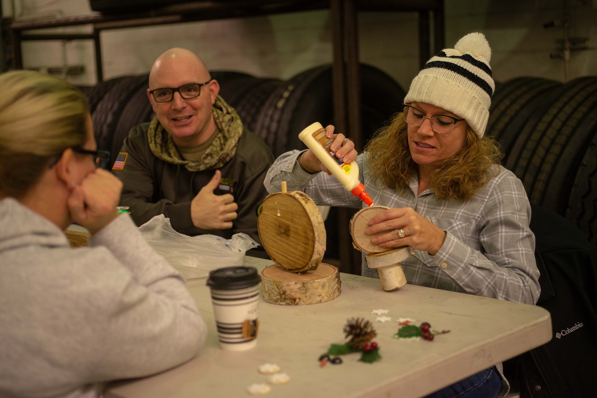 Airmen and families of the 354th Logistics Readiness Squadron build birch snowmen during a monthly squadron gathering, Nov. 7, 2019, at Eielson Air Force Base, Alaska. Attendees built both crafts and relationships while connecting with Air Force families. (U.S. Air Force photo by Capt. Kay NIssen)