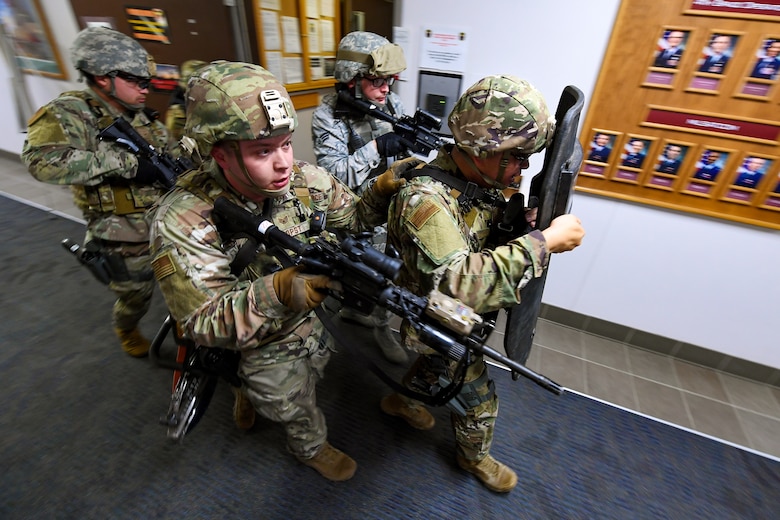 Members of the 50th Security Forces Squadron team line up in a diamond formation behind a crisis response shield during an active-shooter exercise on Schriever Air Force Base.