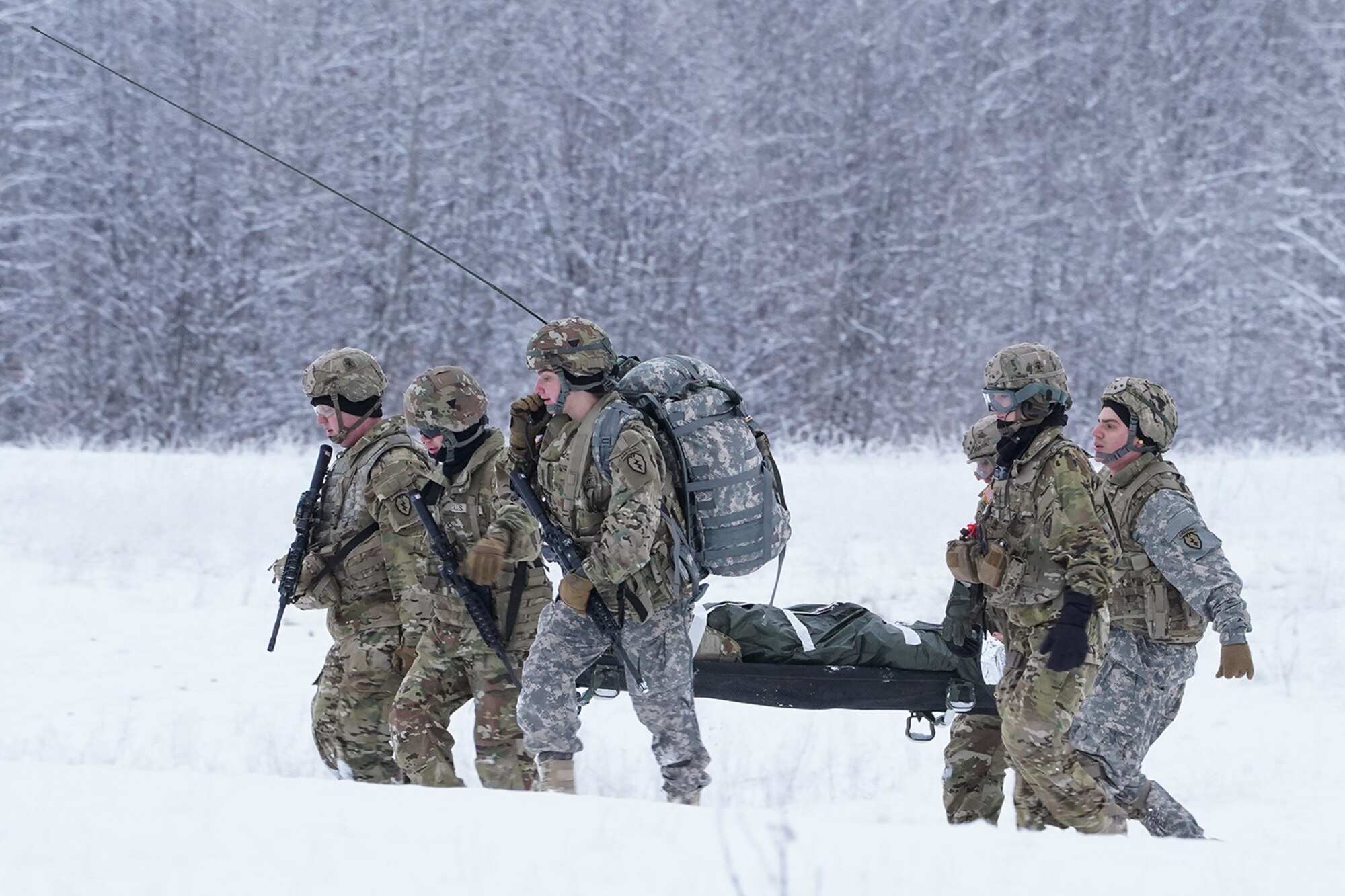 Medics from the 6th Brigade Engineer Battalion (Airborne), 4th Infantry Brigade Combat Team (Airborne), 25th Infantry Division, U.S. Army Alaska, carry a simulated casualty to an extraction point while training with aviators from the Alaska Army National Guard at Neibhur Drop Zone, Nov. 26, 2019, to hone their life-saving and Medevac hoist skills for the paratroopers’ upcoming rotation to the Joint Readiness Training Center at Fort Polk, La.