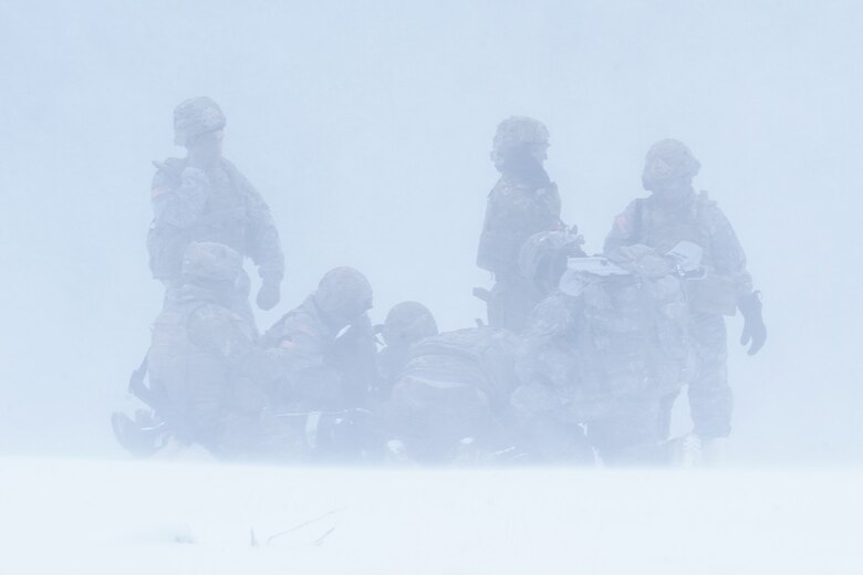 Medics from the 6th Brigade Engineer Battalion (Airborne), 4th Infantry Brigade Combat Team (Airborne), 25th Infantry Division, U.S. Army Alaska, prepare a simulated casualty for transport at an extraction point while training with aviators from the Alaska Army National Guard at Neibhur Drop Zone, Nov. 26, 2019, to hone their life-saving and Medevac hoist skills for the paratroopers’ upcoming rotation to the Joint Readiness Training Center at Fort Polk, La.
