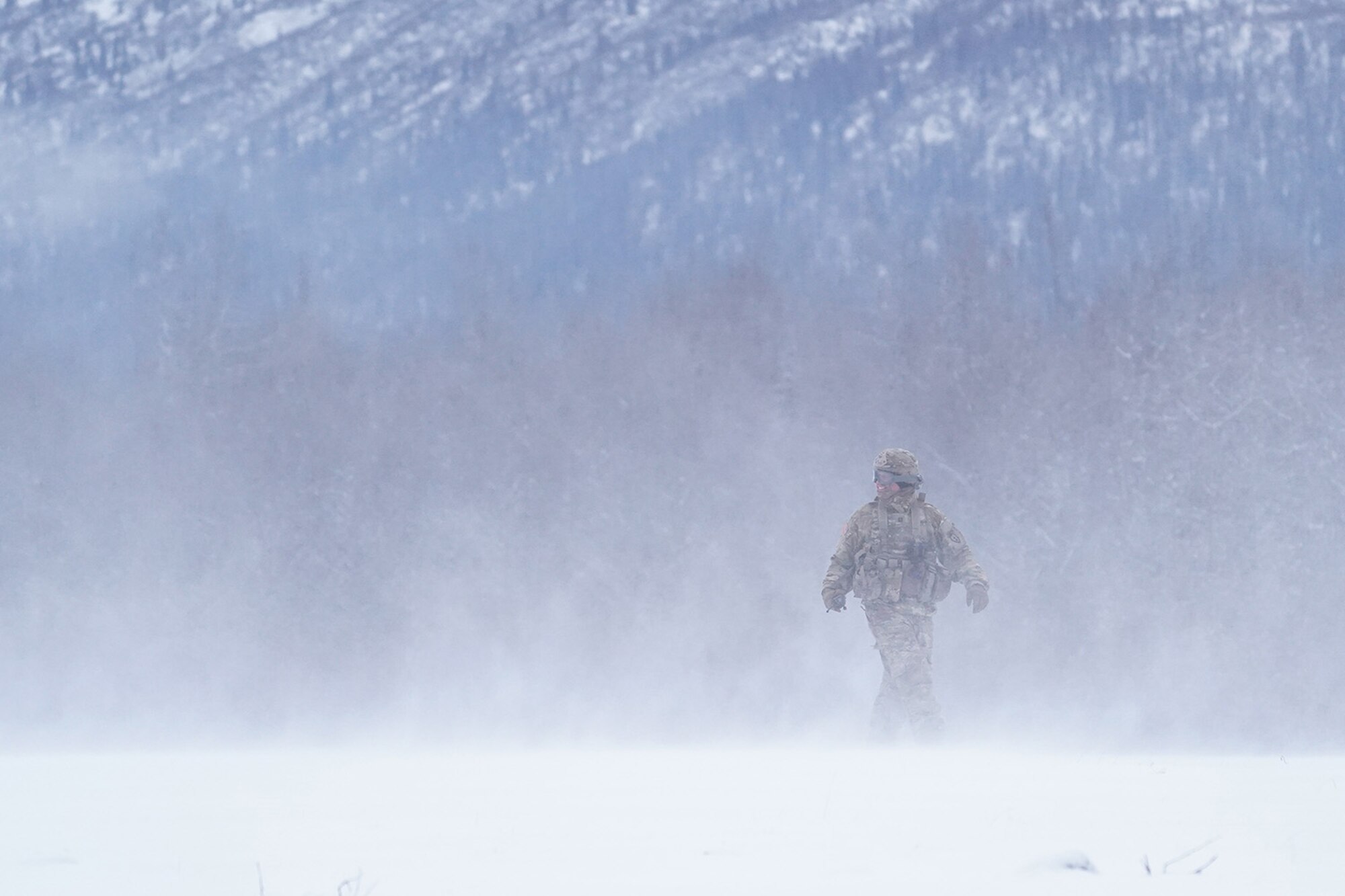 A soldier assigned the 6th Brigade Engineer Battalion (Airborne), 4th Infantry Brigade Combat Team (Airborne), 25th Infantry Division, U.S. Army Alaska, smiles as he looks into a helicopter’s rotor wash while training with aviators from the Alaska Army National Guard at Neibhur Drop Zone, Nov. 26, 2019, to hone their life-saving and Medevac hoist skills for the paratroopers’ upcoming rotation to the Joint Readiness Training Center at Fort Polk, La.