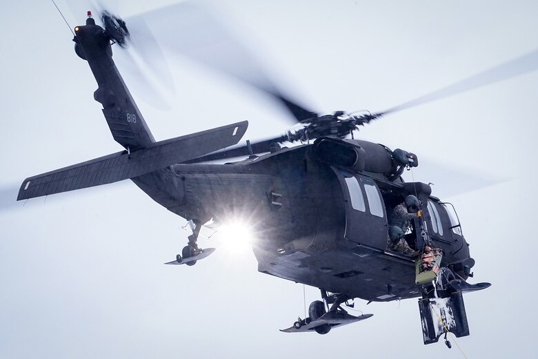 Alaska Army National Guard aviators hoist a simulated casualty with a UH-60 Black Hawk helicopter on Neibhur Drop Zone, Nov. 26, 2019, while assisting Soldiers from the 6th Brigade Engineer Battalion (Airborne), 4th Infantry Brigade Combat Team (Airborne), 25th Infantry Division, U.S. Army Alaska, honing their life-saving and Medevac hoist skills for the paratroopers’ upcoming rotation to the Joint Readiness Training Center at Fort Polk, La.