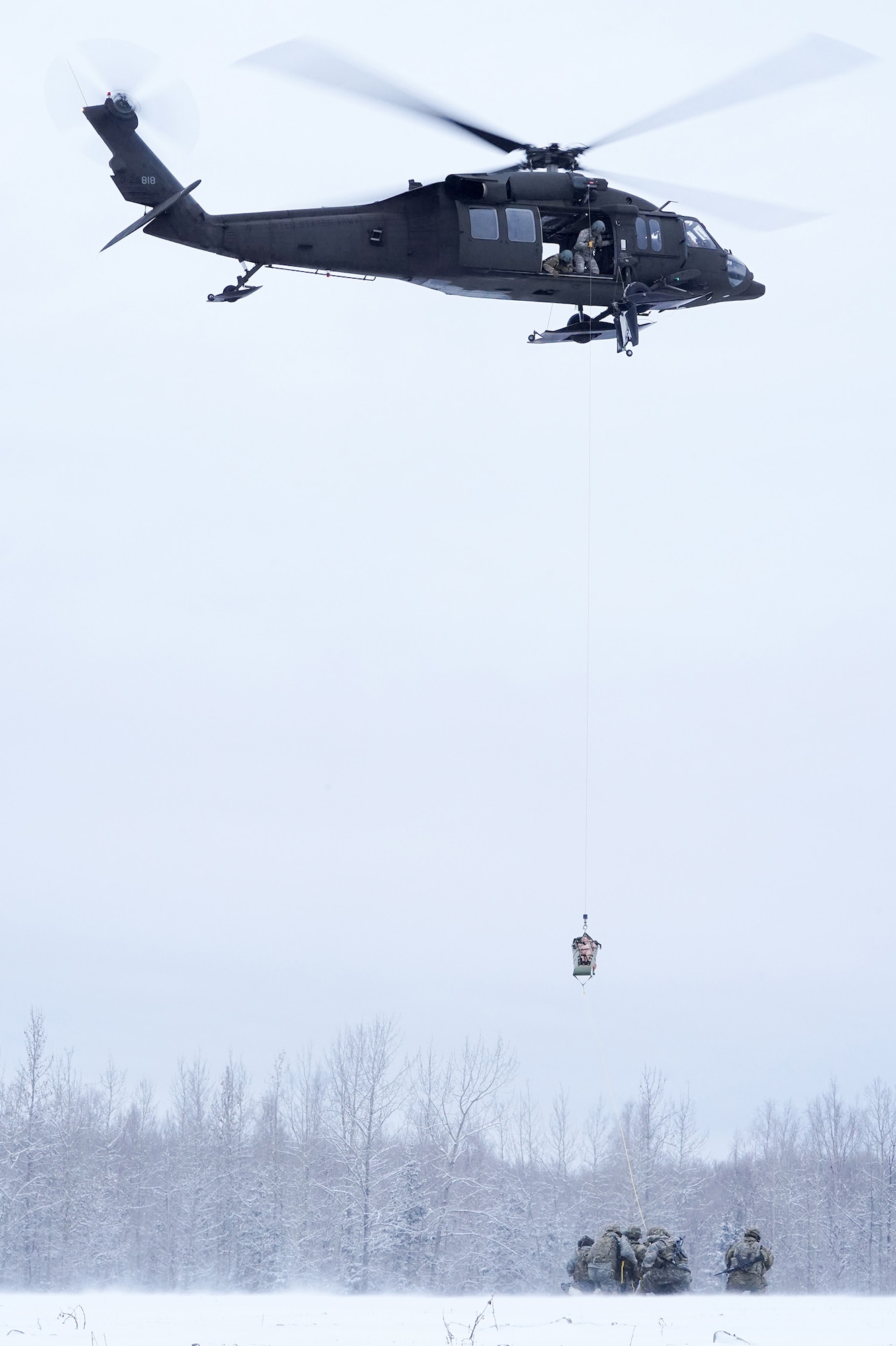 Alaska Army National Guard aviators hoist a simulated casualty with a UH-60 Black Hawk helicopter on Neibhur Drop Zone, Nov. 26, 2019, while assisting Soldiers from the 6th Brigade Engineer Battalion (Airborne), 4th Infantry Brigade Combat Team (Airborne), 25th Infantry Division, U.S. Army Alaska, honing their life-saving and Medevac hoist skills for the paratroopers’ upcoming rotation to the Joint Readiness Training Center at Fort Polk, La.