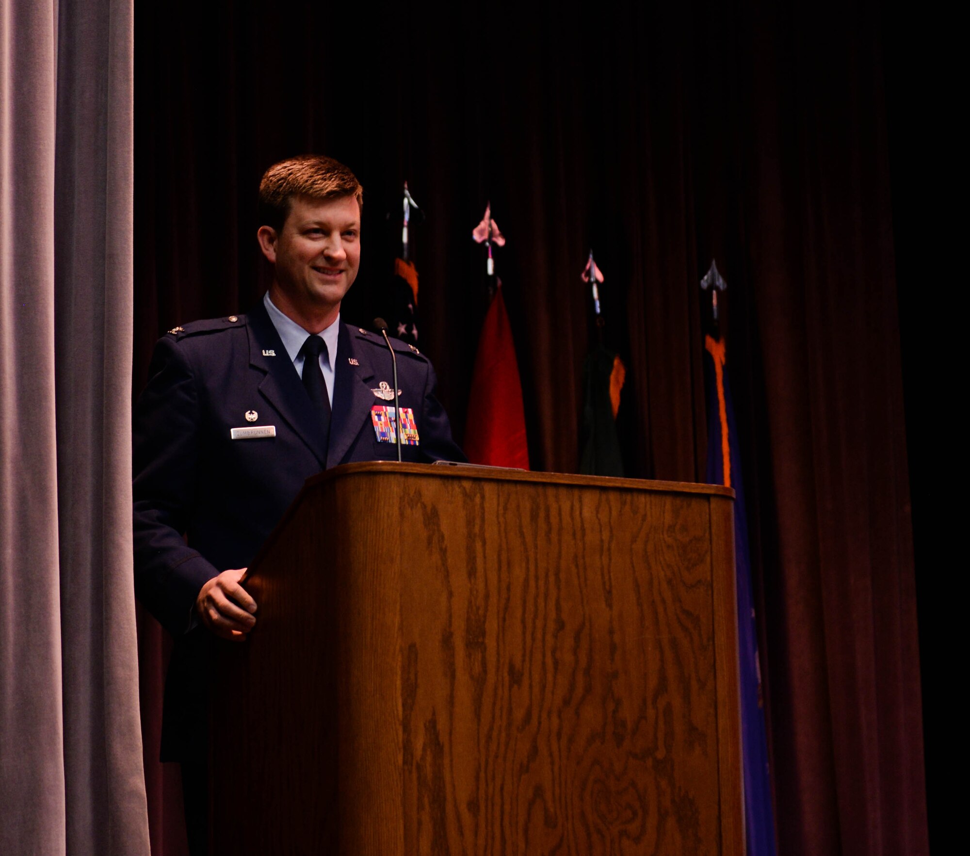 Col. Clinton ZumBrunnen, 437th Airlift Wing commander at Joint Base Charleston, South Carolina, gives a speech at the graduation ceremony of Specialized Undergraduate Pilot Training Class 20-03 Nov. 15, 2019, at Columbus Air Force Base, Miss. During his speech, he told the graduates a story about retired U.S. Army Staff Sgt. Dan Powers, a former squadron leader of the 118th Military Police Company, and how an aircrew’s skillful tactics helped save his life. (U.S. Air Force photo by Airman Davis Donaldson)