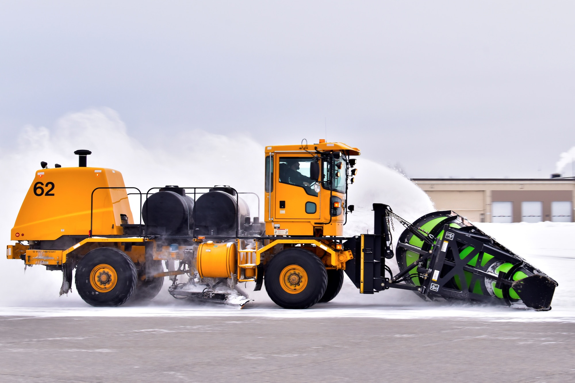 A 354th Civil Engineer Squadron pavements and construction equipment operator plows snow from the flight line at Eielson Air Force Base, Alaska, Nov. 26, 2019. The Airmen at the snow barn keep the infrastructure of the base as safe as possible by removing snow and ice in order to maintain a mission-ready status. (U.S. Air Force photo by Senior Airman Beaux Hebert)