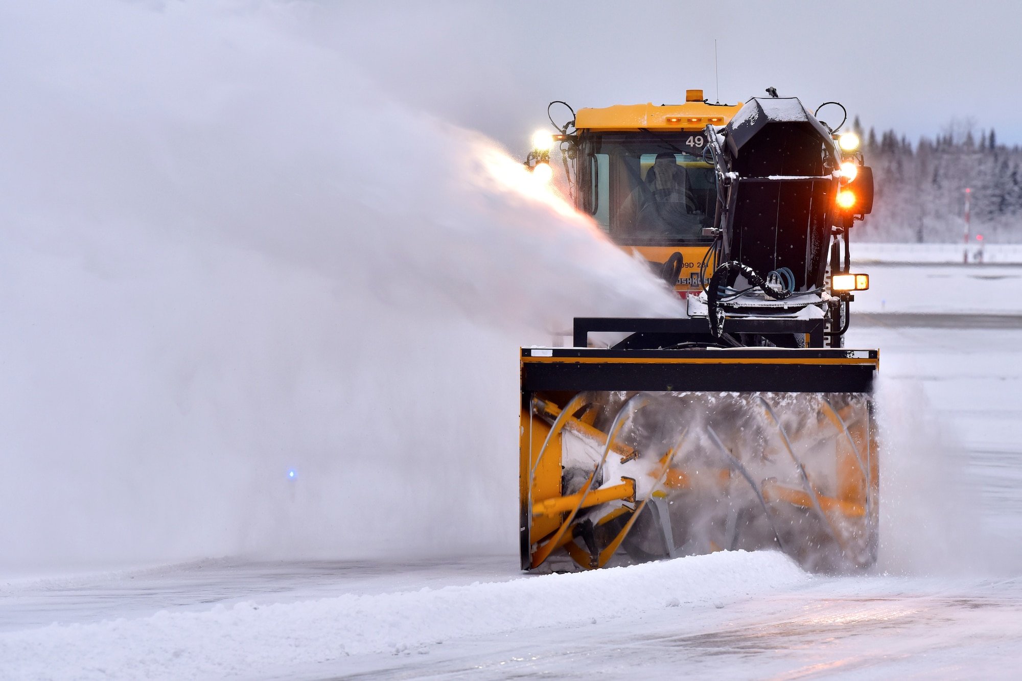 A 354th Civil Engineer Squadron pavements and construction equipment operator removes snow from the flight line at Eielson Air Force Base, Alaska, Nov. 26, 2019.  The runway at Eielson is always active, and therefore must remain free of debris at all times. (U.S. Air Force photo by Senior Airman Beaux Hebert)