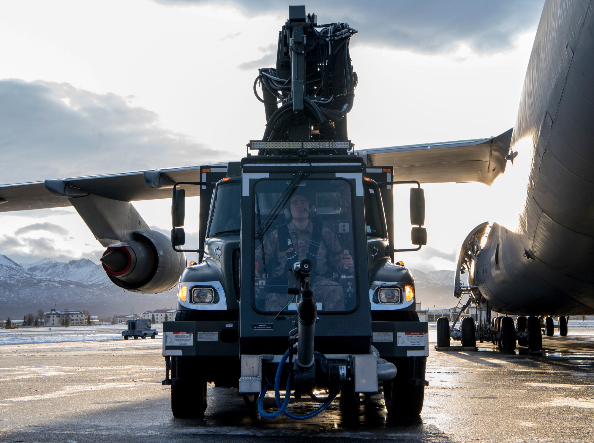 U.S. Air Force Staff Sgt. Damien Sloan, 821st Contingency Response Squadron, contingency response maintenance craftsman assigned to Travis Air Force Base, Calif., operates de-icing equipment on a C-5M Super Galaxy assigned to Travis during cold weather aircraft maintenance procedures training at Joint Base Elmendorf-Richardson, Alaska, Nov. 20, 2019. The training prepared Airmen to operate in arctic environments.