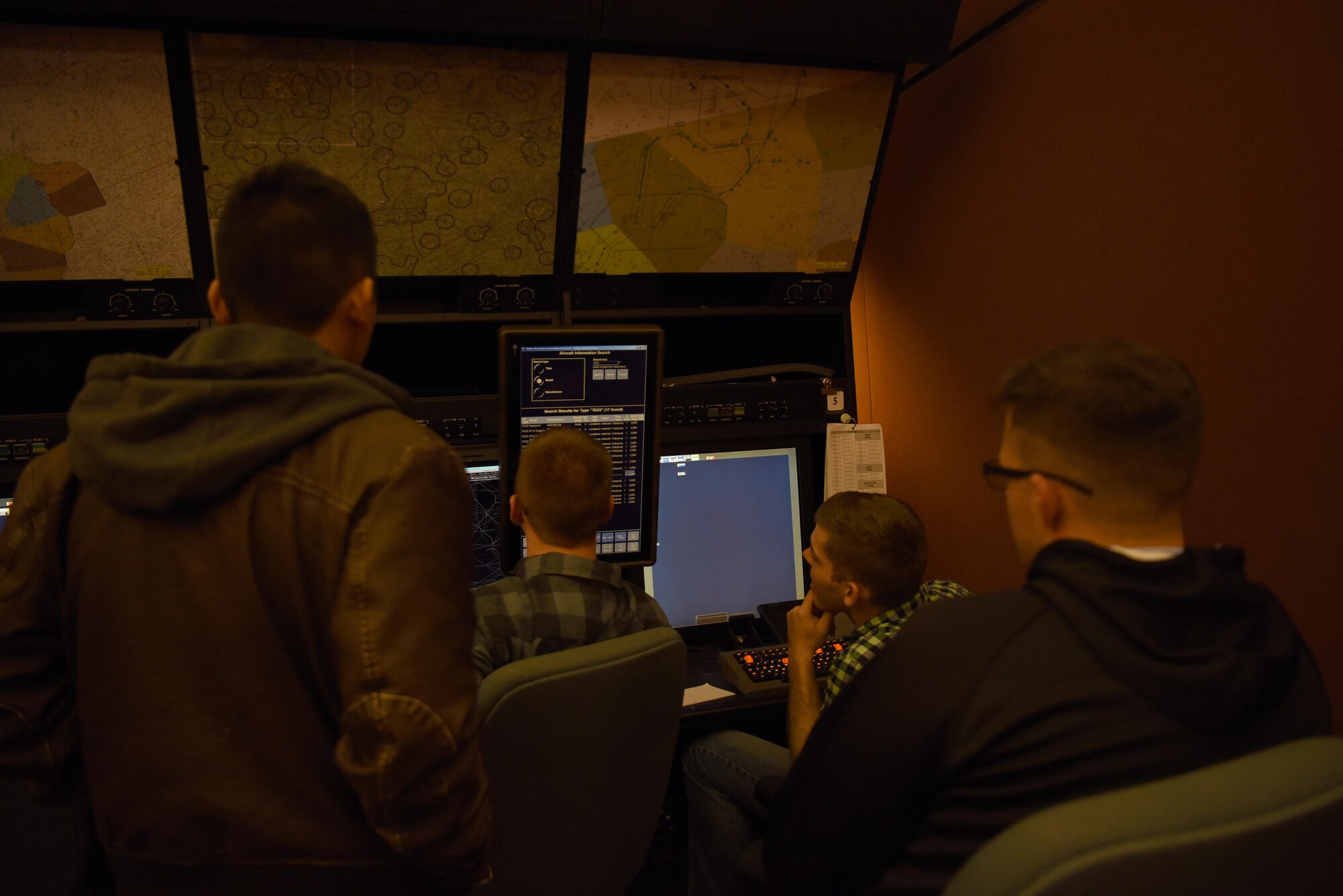 Instructor pilots, RAPCON and tower controllers from Columbus Air Force Base interacting with monitors in a training room Nov. 22, 2019, at the Memphis Center, Tenn. The Memphis Center’s airspace coverage overlaps Columbus’s so when the bases RAPCOM and tower Airmen aren’t working it is the Memphis Center controllers working our airspace. (U.S. Air Force photo by Airmen 1st Class Jake Jacobsen)