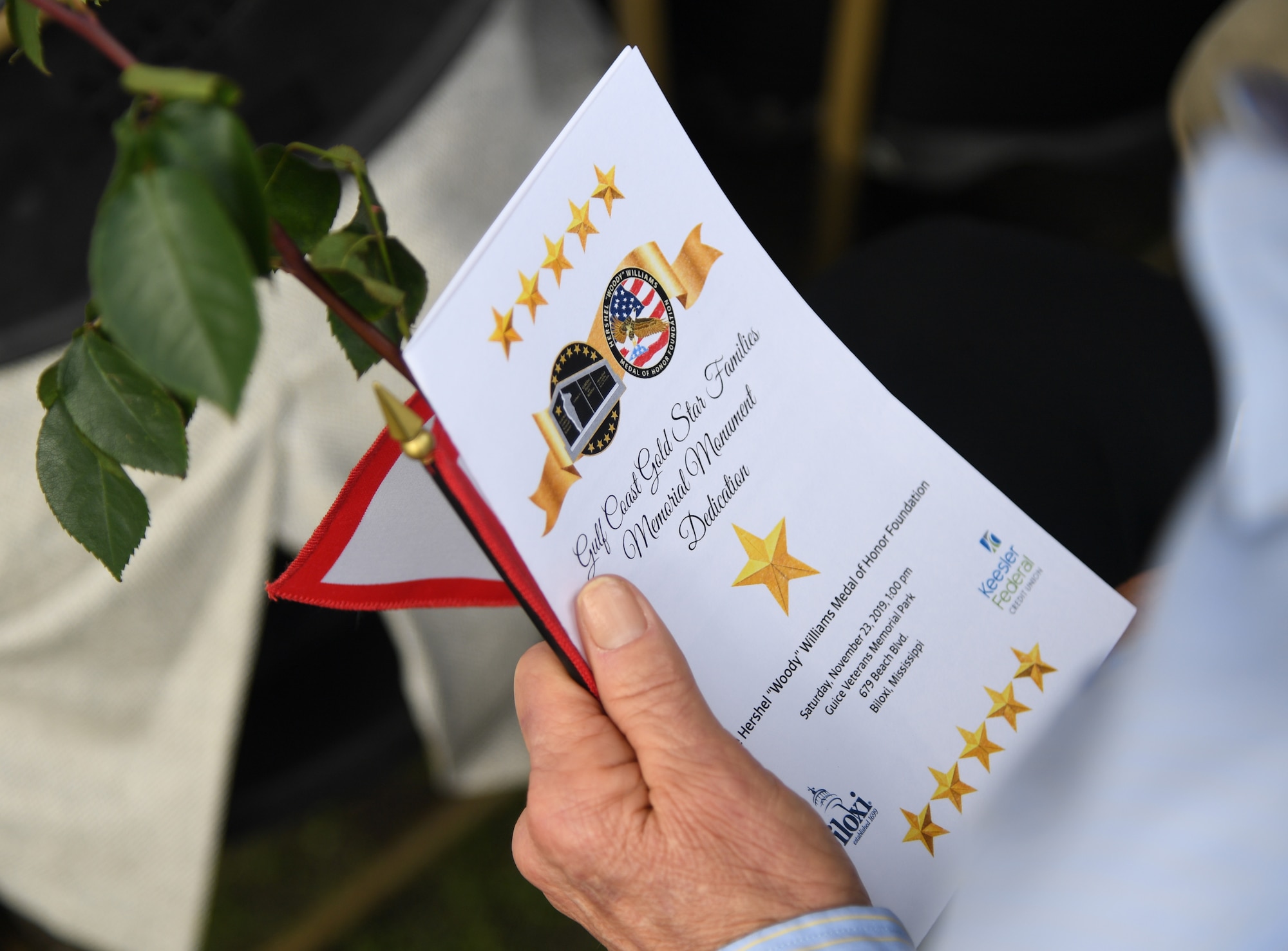 Ashton Belcher, Gold Star family member, holds an event program during the Gold Star Families Memorial Monument dedication ceremony at Guice Veterans Memorial Park in Biloxi, Mississippi, Nov. 23, 2019. The monument honors families of service men and women who sacrificed their lives while serving in the military. (U.S. Air Force photo by Kemberly Groue)