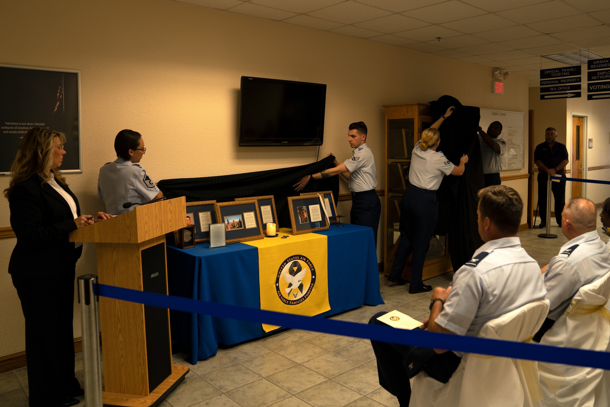 Airmen unveil the Fallen Heroes Cabinet display in the Sablich Center at Keesler Air Force Base, Mississippi, Sept. 30, 2019. The display was dedicated to Gold Star families to maintain the memory of fallen heroes and let the families know they are not forgotten. (U.S. Air Force photo by Airman 1st Class Kimberly Mueller)