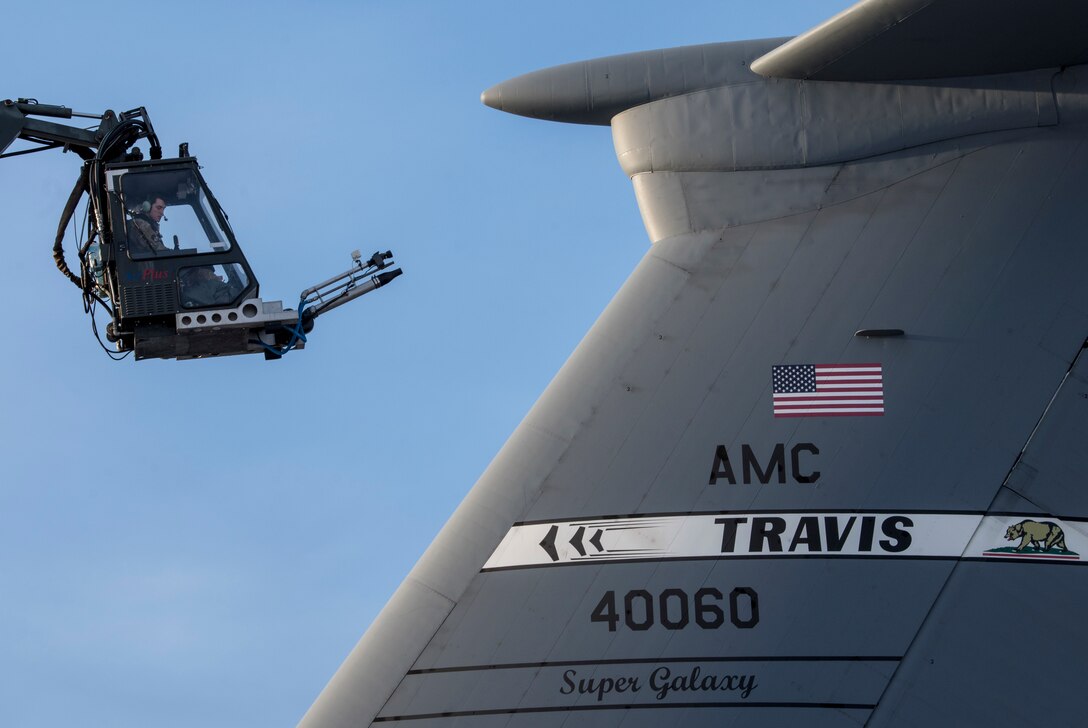 U.S. Air Force Staff Sgt. Damien Sloan, 821st Contingency Response Squadron, contingency response maintenance craftsman assigned to Travis Air Force Base, Calif., operates de-icing equipment on a C-5M Super Galaxy assigned to Travis during cold weather aircraft maintenance procedures training at Joint Base Elmendorf-Richardson, Alaska, Nov. 20, 2019. The training prepared Airmen to operate in arctic environments.