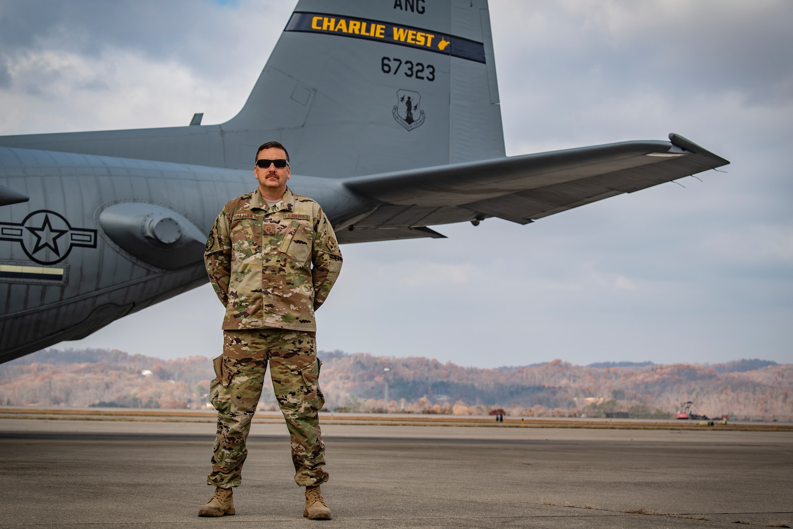 Master Sgt. Darrin Hazuka, a crew chief assigned to the 130th Aircraft Maintenance Squadron, poses for a portrait in front of a C-130H at McLaughlin Air National Guard Base, Charleston, W.Va. (U.S. Air National Guard Photo by Senior Airman Caleb Vance)