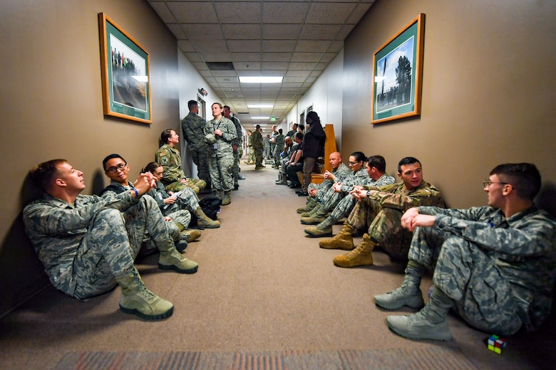 Members of the 50th Space Wing execute tornado warning emergency procedures during exercise Opinicus Vista 19-3 in Building 300 at Schriever Air Force Base, Colorado, Nov. 19, 2019.