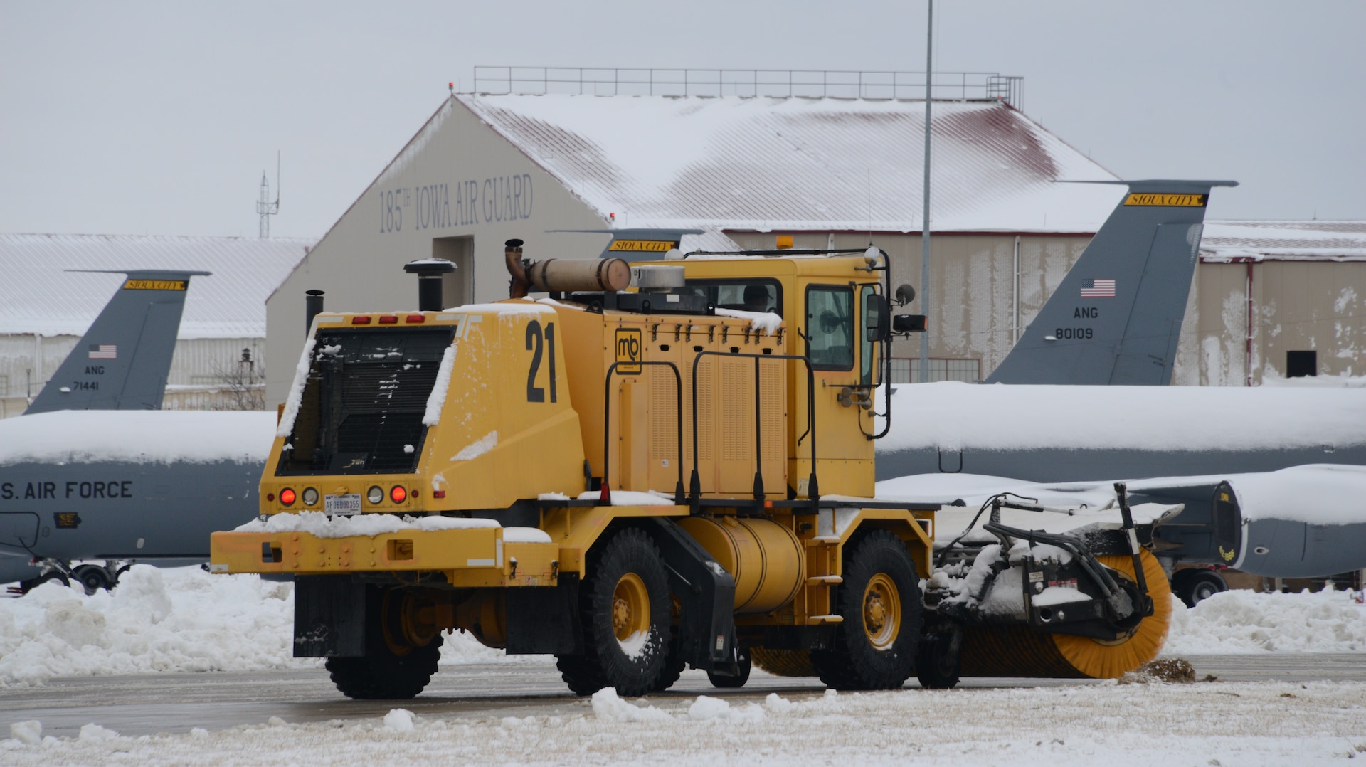 A member the 185th Air Refueling Wing snow removal team clears snow on the ramp area at the Sioux City, Iowa, base Air Guard unit on Nov. 27, 2019.
