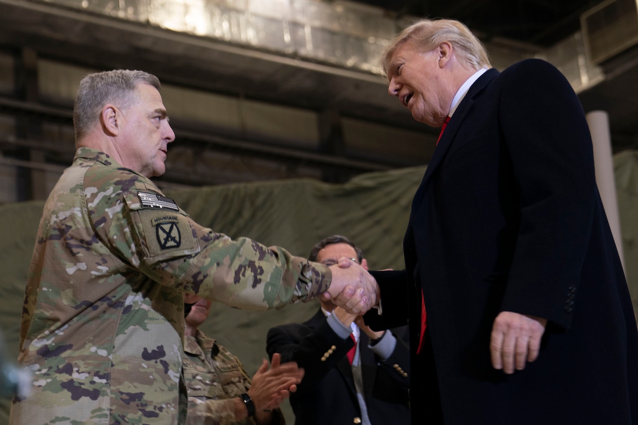 Two men shake hands.