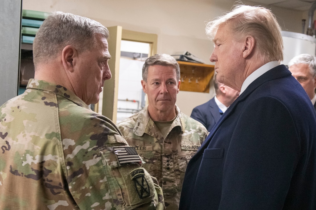 Three leaders stand together and talk.