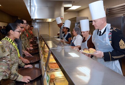 Maj. Gen. Patrick D. Sargent and Command Sgt. Maj. Buck O'Neal, along with other U.S. Army Medical Center of Excellence leaders, served Thanksgiving luncheon to Soldiers at the Slagel Dinning Facility at Joint Base San Antonio-Fort Sam Houston Nov. 28. The time-honored military tradition of senior leaders serving Thanksgiving Day dinner to Soldiers is an example of how military service is like an extended family. For many, this is their first time away from home and their first holiday away from home.