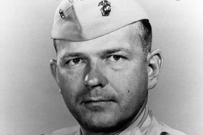 Photo of a Marine Corps colonel wearing his khaki dress uniform, cap and Medal of Honor.