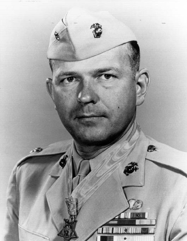 Photo of a Marine Corps colonel wearing his khaki dress uniform, cap and Medal of Honor.