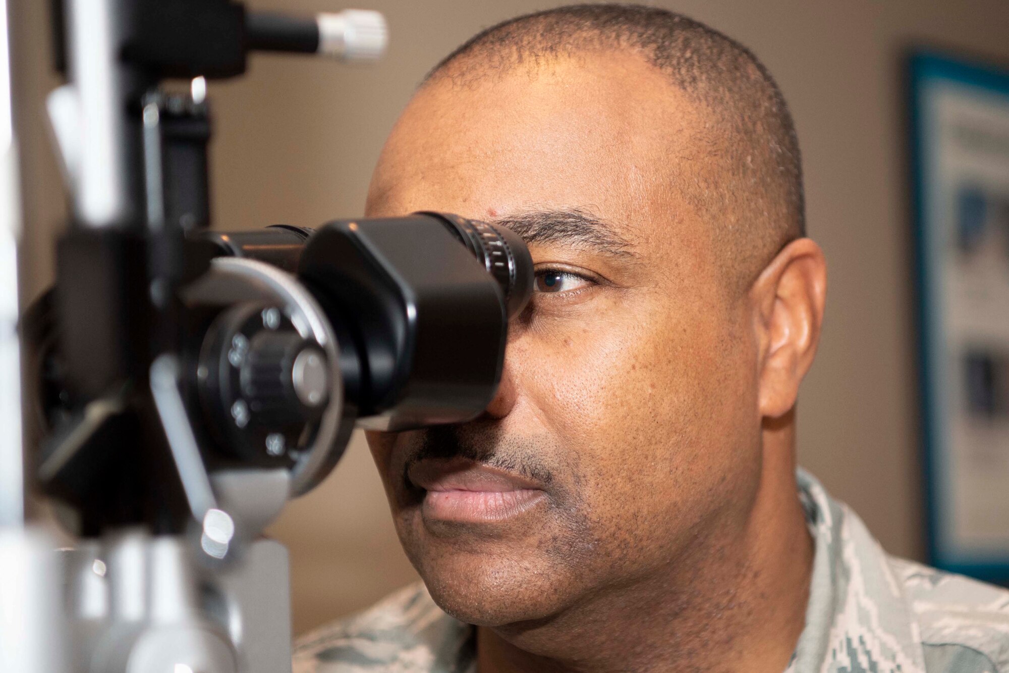 A U.S. Air Force optometrist performs and eye exam.