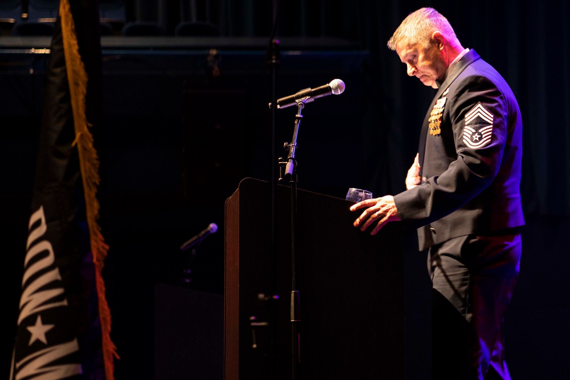 Retired U.S. Air Force Chief Master Sgt. Steve Vogel pauses during a speech.