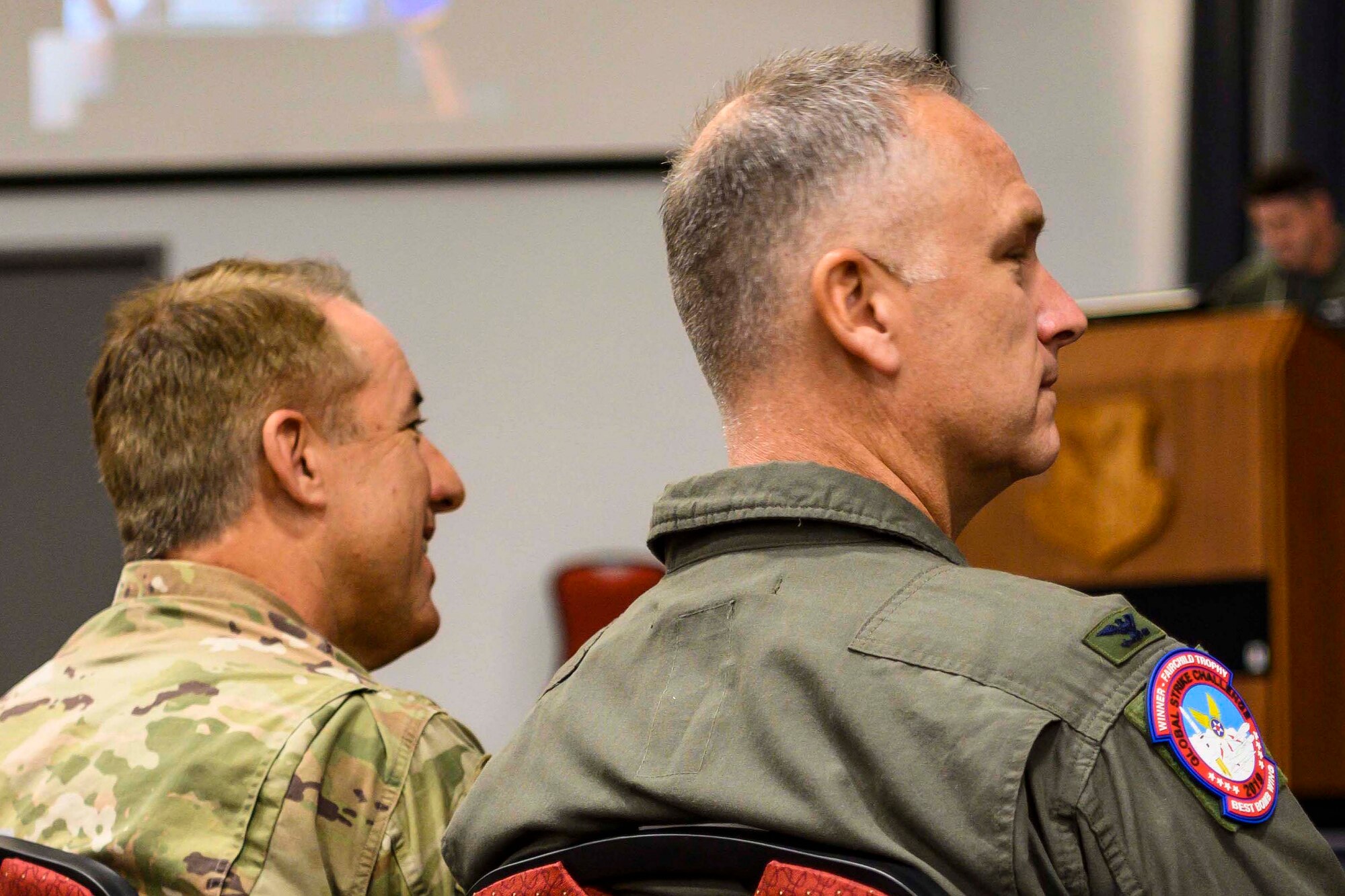 Photo of two wing commanders watching FTU graduation.