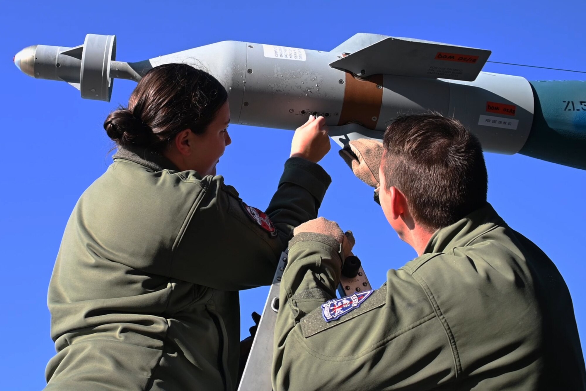U.S. Air Force Airmen check out a munition on a B-52 Stratofortress.