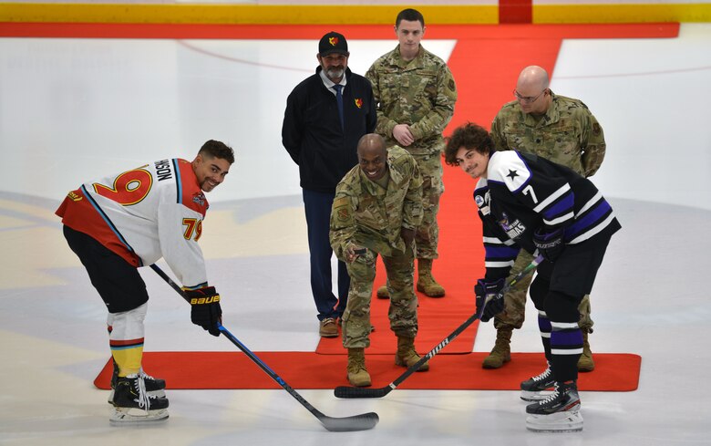Air Force Col. Gregory Coleman poses for a photo before dropping the ceremonial first puck