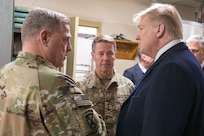 Three leaders stand together and talk.