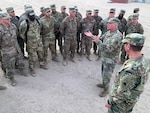 Army Brig. Gen. Kenneth Brandt, National Guard Bureau chaplain, talks with service members during Thanksgiving troop visits, Kuwait, Nov. 27, 2019. This image was acquired using a cellular phone.